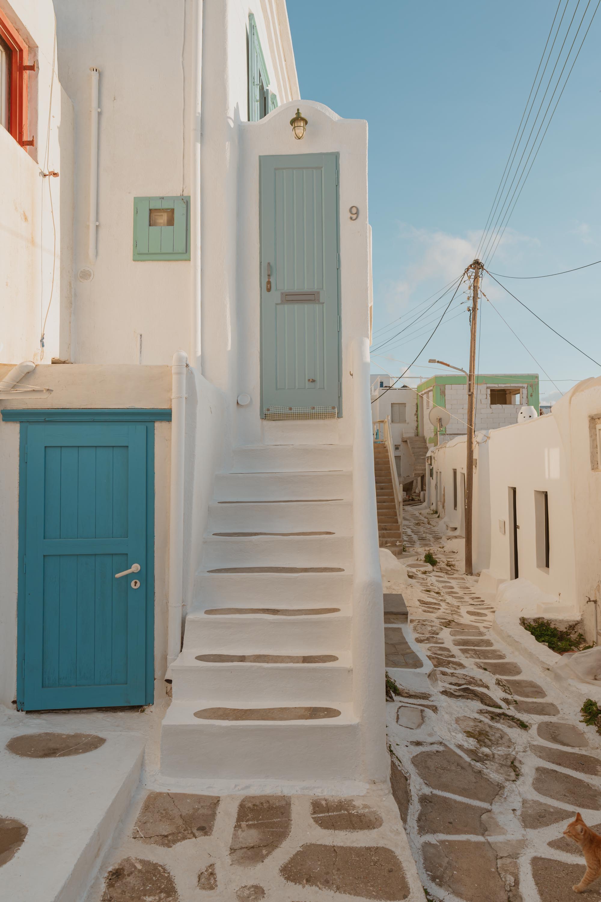 Cobblestone alley with teal door
